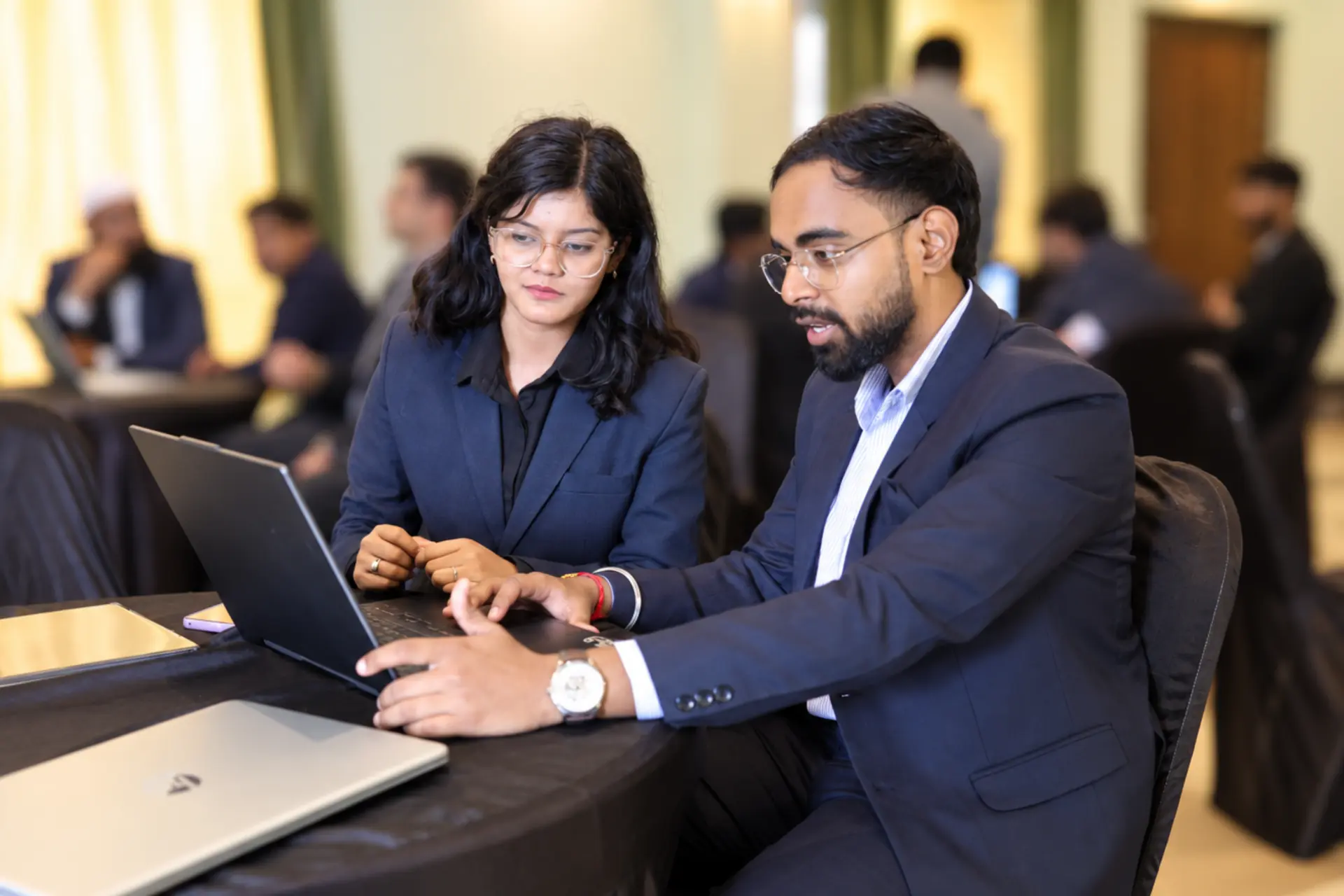 Two Xcelerate Advisory colleagues working side by side at a laptop